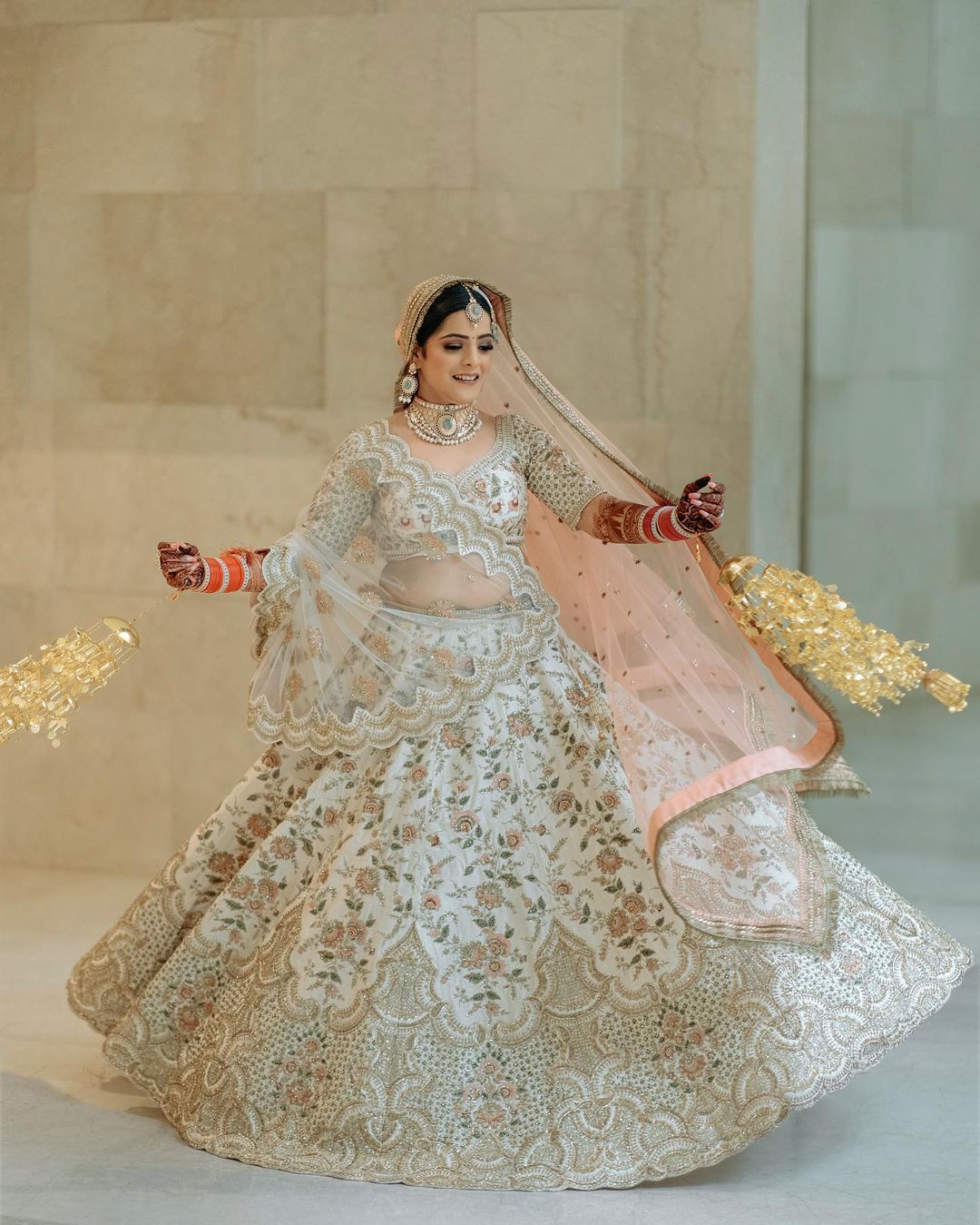 Bride twirling in an embroidered lehenga