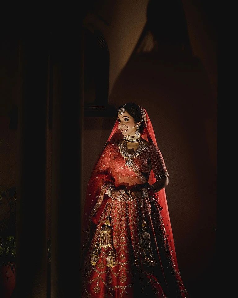 Bride in red lehenga in cinematic light