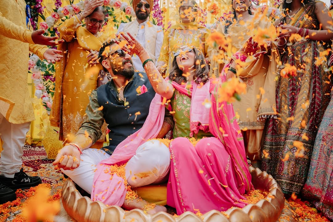 Couple during haldi in pink and green